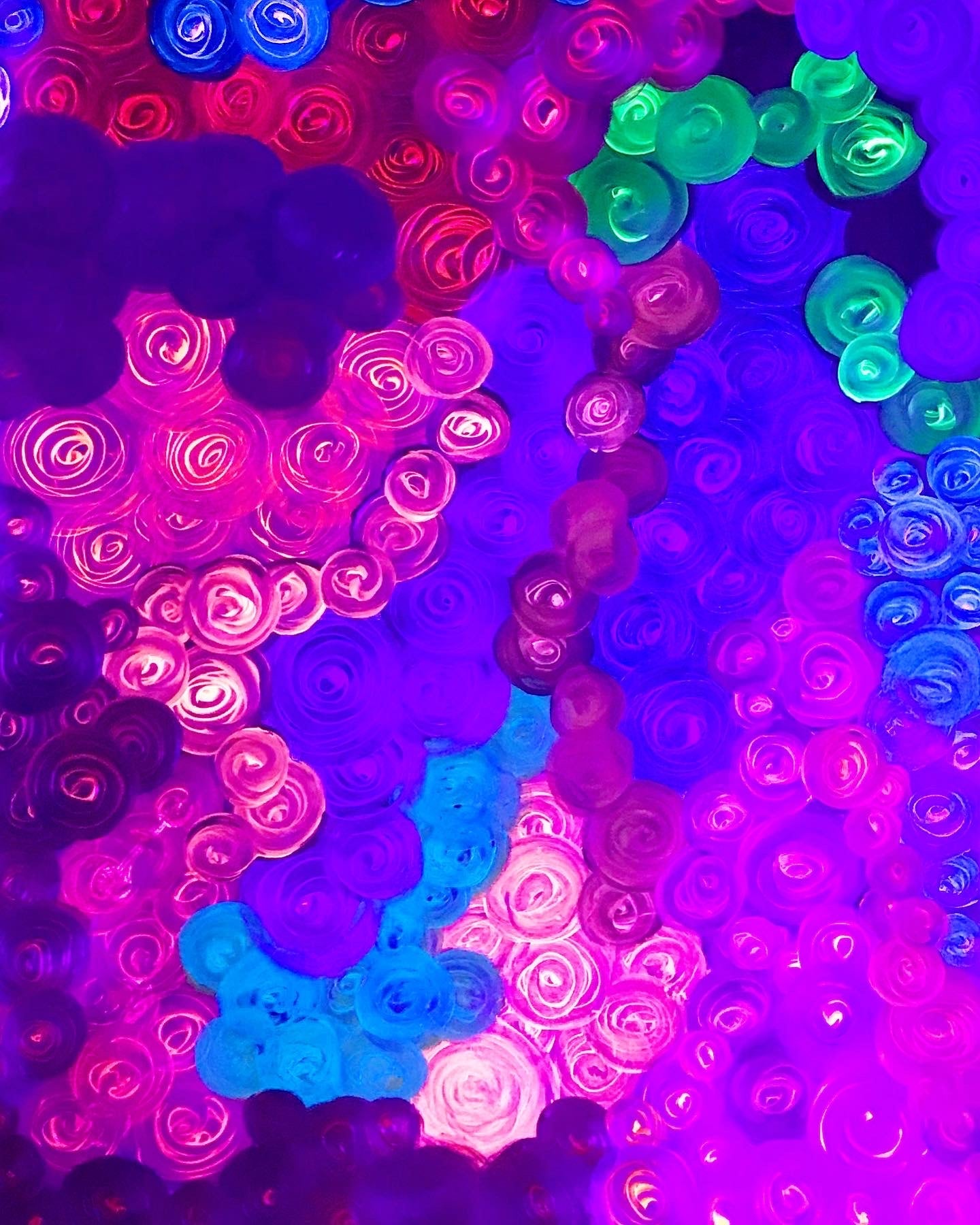 Metallic and fluorescent acrylics painting with colorful rosettes, under UV light